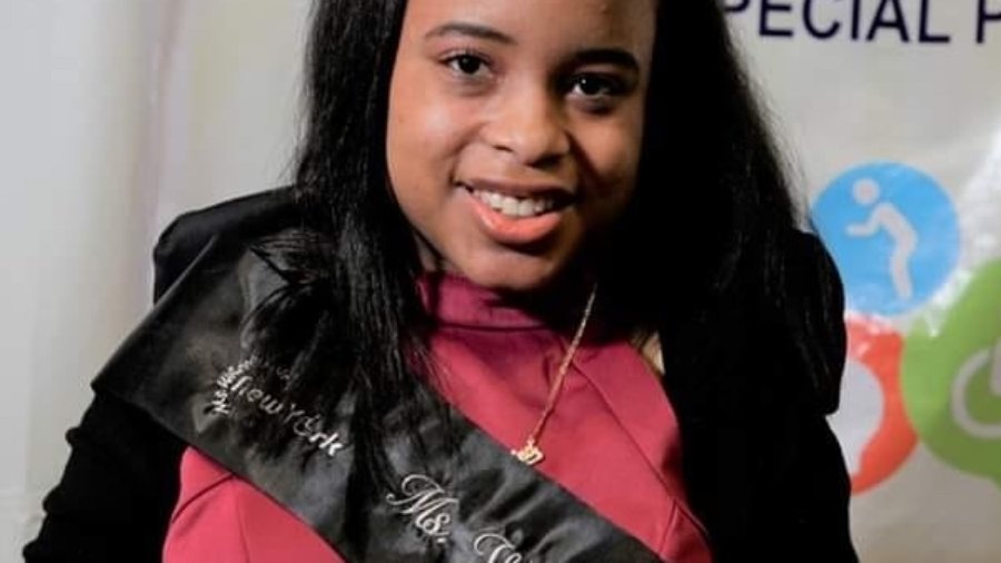 Ketrina Hazell headshot smiling wearing a sash that says Ms. Wheelchair New York on it