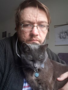 Philip Kahn-Pauli with his cat Misty on his lap.