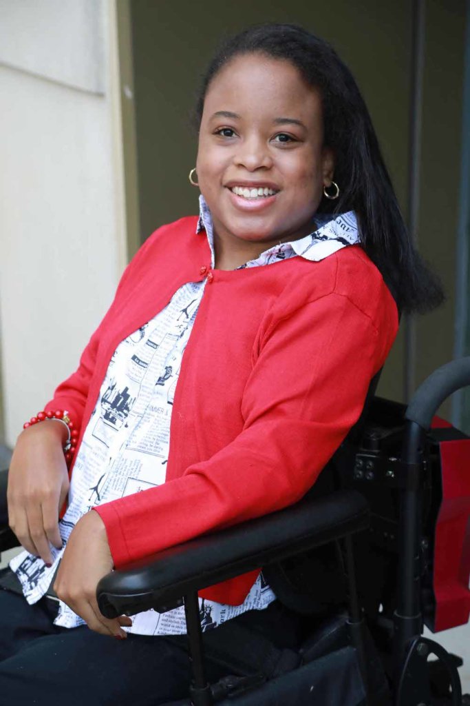 Ketrina Hazell seated in her wheelchair, smiling