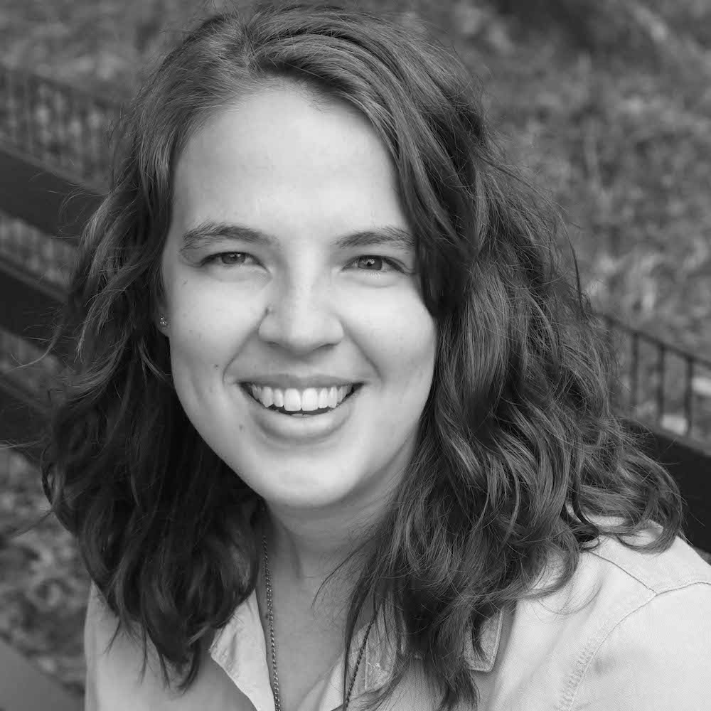 Abigail Shaw smiling seated on a bench outside