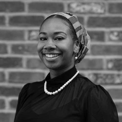 Chiquita Jackson smiling headshot in front of a brick wall