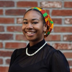 Chiquita Jackson smiling headshot in front of a brick wall