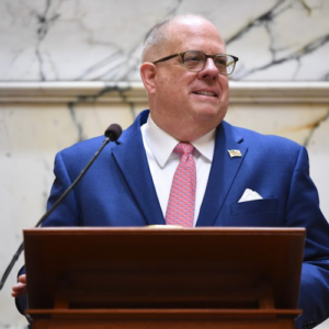 Governor Larry Hogan smiling, speaking behind a podium