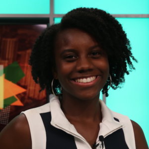 Kianna Dorsey smiling headshot on a television set