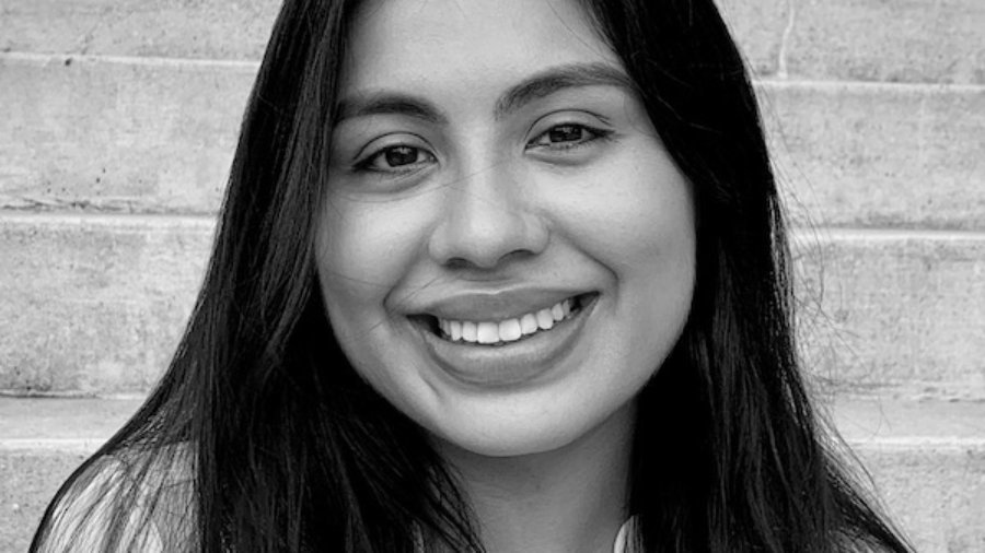 Maria Heredia smiling headshot in front of a staircase