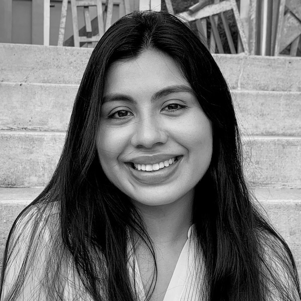 Maria Heredia smiling headshot in front of a staircase