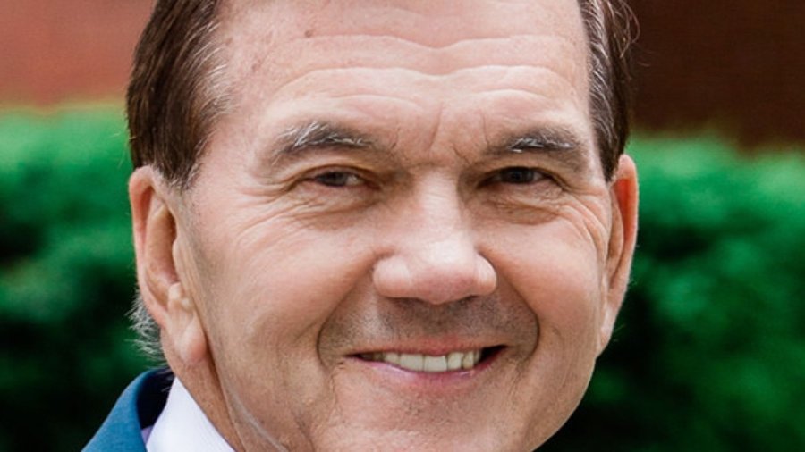 Governor Tom Ridge headshot wearing a blue suit and pink tie. Ridge is a white man who has short brown hair