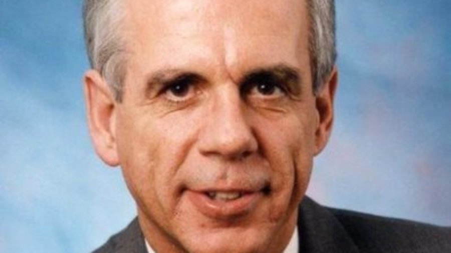 Hon. Tony Coelho headshot wearing a suit and tie. Coelho is a white man with short grey hair