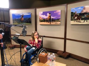 Cassidy Huff seated in her wheelchair in a recording studio