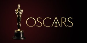 An Oscar statue next to the logo for the Oscars