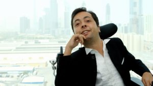 Dr. Victor Pineda with a backdrop of a city's skyline behind him