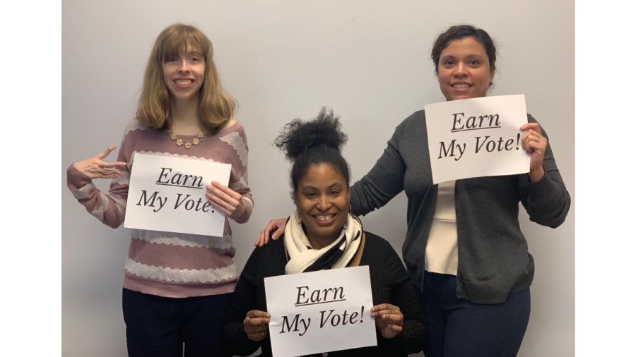 Three RespectAbility team members holding up signs that say 