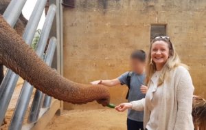 Rachael Risby Raz feeding an elephant at the Tisch Family Biblical Zoo