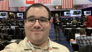 Eric Ascher smiles in the spin room at the 2020 Democratic Debate in Des Moines Iowa