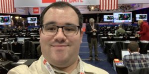 Eric Ascher smiles in the spin room at the 2020 Democratic Debate in Des Moines Iowa