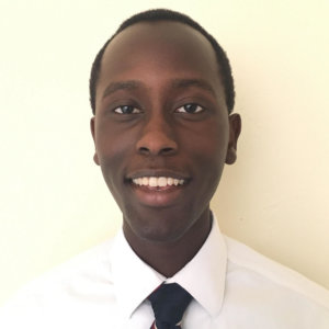 Ian Cherutich smiling headshot wearing a white shirt and black tie