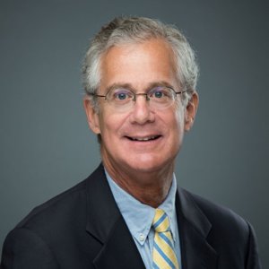 Michael Morris smiling headshot wearing a suit and tie