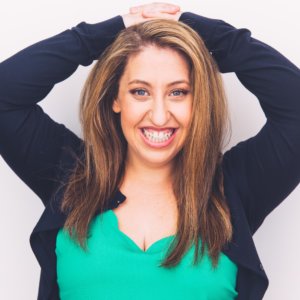 Pamela Schuller smiling headshot with her hands behind her head