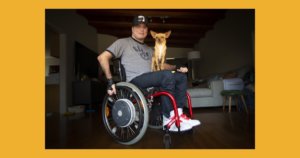 Roque Renteria with his dog on his lap. Roque is a wheelchair user.