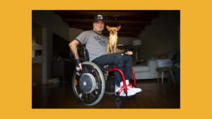 Roque Renteria with his dog on his lap. Roque is a wheelchair user.