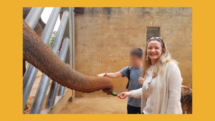 Rachael Risby Raz feeding an elephant at the Tisch Family Biblical Zoo