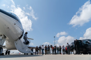 Senator Kamala Harris exits an airplane as press take photos and videos