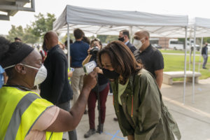Kamala Harris gets her temperature checked before visiting the Red Cross in Fresno, California. Nasreen is behind her filming.