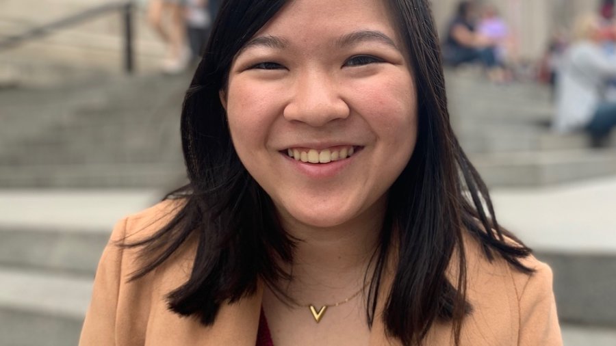 Vanni Le smiling headshot in front of a staircase