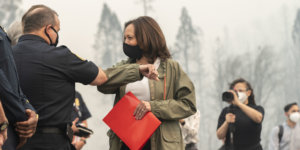 Kamala Harris bumps elbows with a firefighter in Auberry California. Nasreen Alkhateeb is in the background filming