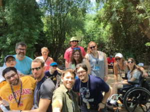 Blair Webb and other participants in the birthright trip smile together in the woods
