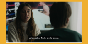 A scene from Alive with a woman speaking to another woman with a disability. Subtitle reads "Let's create a Tinder profile for you."