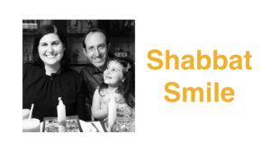 Lauren Appelbaum with her husband and daughter celebrating Passover. Text: Shabbat Smile