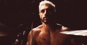 Riz Ahmed shirtless at a drum set in the poster for Sound of Metal