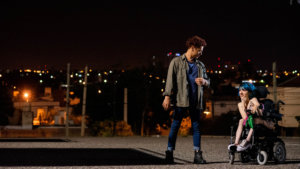 Two people talk at night, including a woman who is using a wheelchair, in a still from 4 Feet High by María Belén Poncio and Rosario Perazolo Masjoan, an official selection of the Indie Series Program at the 2021 Sundance Film Festival.
