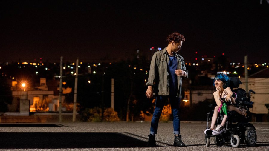 Two people talk at night, including a woman who is using a wheelchair, in a still from 4 Feet High by María Belén Poncio and Rosario Perazolo Masjoan, an official selection of the Indie Series Program at the 2021 Sundance Film Festival.