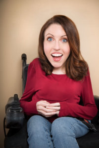 Shannon DeVido smiling headshot. DeVido is a wheelchair user