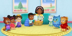 A scene from Daniel Tiger's Neighborhood with Max and all of the o there characters on a rug listening to a story