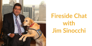 Jim Sinocchi sitting with a service dog in front of a window with skyscrapers behind him. Text: Fireside Chat with Jim Sinocchi