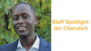 Headshot of Ian Cherutich smiling in front of trees and bushes. Text: Staff Spotlight: Ian Cherutich