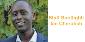 Headshot of Ian Cherutich smiling in front of trees and bushes. Text: Staff Spotlight: Ian Cherutich