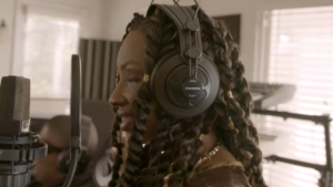 Natalie Trevonne as NayNay Too Bomb in a recording studio