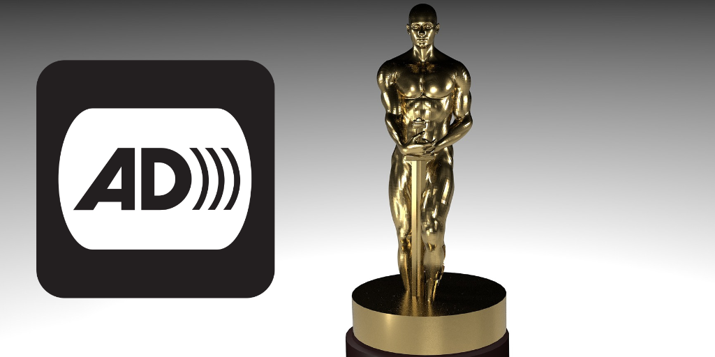An award statue next to the icon for audio description
