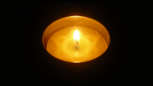 A lit Yom Hashoah candle