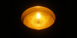 A lit Yom Hashoah candle