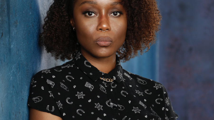 Cashmere Jasmine headshot in front of a blue wall