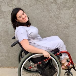 Cami Howe smiling leaning back in her wheelchair