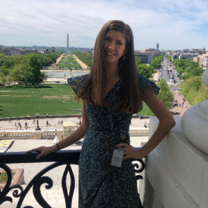 Claudia Runk smiling with the national mall behind her.