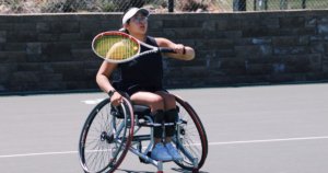Krista Ramirez-Villatoro playing tennis. She is a wheelchair user.