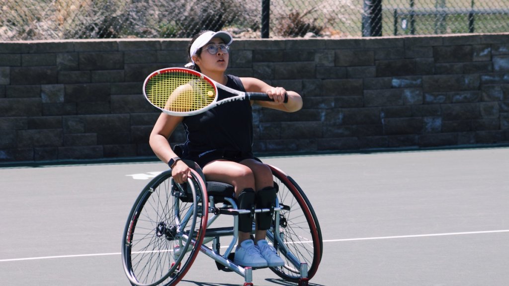 Krista Ramirez-Villatoro playing tennis. She is a wheelchair user.