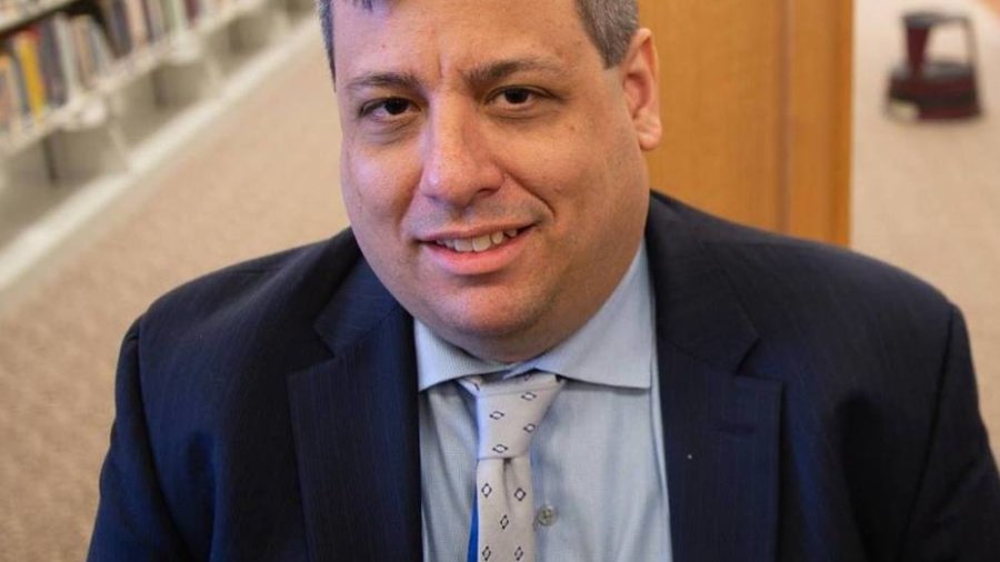 Michael Gilberg smiling headshot wearing a suit and tie